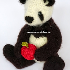 May include: A handmade panda bear plushie with a white and brown color scheme, holding a red apple. The bear has black button eyes and a button on its chest. Text on the image reads "PDF PATTERN NOT a finished item."