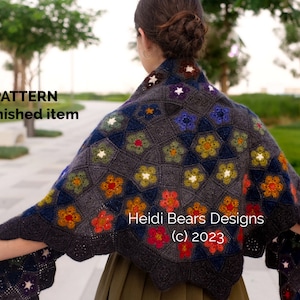 May include: A crochet shawl featuring a colourful floral pattern in shades of red, orange, yellow, green, blue and white. The shawl is made with a dark grey yarn and has a star-shaped design. The text "Heidi Bears Designs (c) 2023" is visible on the shawl. PDF PATTERN NOT a finished item.