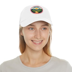 May include: White baseball cap with a pink and green embroidered patch that says "New Year New Adventure".