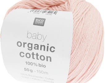 May include: A ball of light pink baby organic cotton yarn. The label reads "RICO DESIGN baby organic cotton 100% bio 50g~150m". The yarn is made of 100% cotton and is suitable for baby projects.