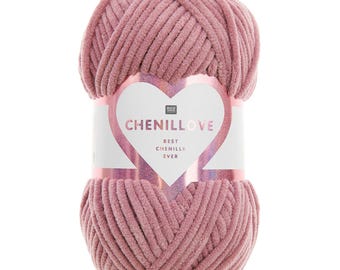 May include: A ball of dusty rose chenille yarn. The yarn is wrapped with a label that reads "CHENILLOVE BEST CHENILLE EVER" in a heart-shaped design. The yarn appears soft and plush, ideal for knitting or crocheting projects.