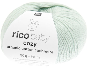 May include: A ball of light green yarn with a label that reads "rico baby cozy organic cotton cashmere". The label features a cartoon bunny and the text "50g ~ 145 m". The yarn is a soft, pastel color, perfect for baby projects.