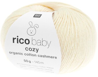 May include: A ball of off-white yarn with a label that reads "rico baby cozy organic cotton cashmere." The label features a bunny illustration. The yarn ball weighs 50 grams and has approximately 145 meters of yarn.