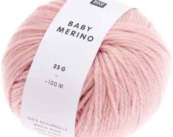 May include: A ball of pale pink Baby Merino yarn. The label displays "BABY MERINO" and "25 G - ~100 M". The yarn is 100% virgin wool. Suitable for knitting and crochet. The yarn is soft and fluffy.