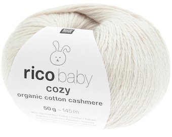 May include: A ball of off-white yarn with a label that reads "rico baby cozy organic cotton cashmere". The label features a bunny illustration. The yarn ball weighs 50 grams and has 145 meters of yarn.