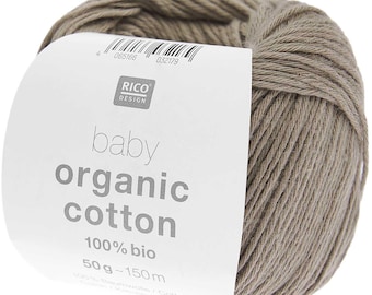May include: A ball of taupe-colored organic cotton yarn. The label reads "baby organic cotton 100% bio" and "50g - 150m". The yarn is from Rico Design.
