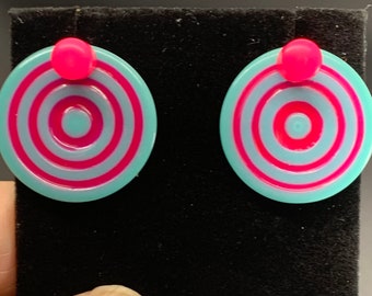 Ear jackets glow in the dark light teal and pink.