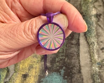 Holographic silver burst in a metallic purple 22 mm bezel so cool reflects very well.