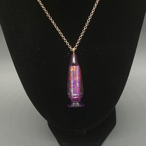 Lava lamp necklace with 360 degrees of rose holographic vinyl. The top and bottom are lavender colored.