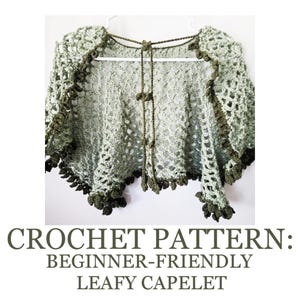 May include: A crocheted capelet in a light green hue with darker green trim and accents. The open-weave design features a leafy pattern along the edges and a tie closure. The text at the bottom reads "CROCHET PATTERN: BEGINNER-FRIENDLY LEAFY CAPELET."