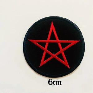 May include: A black and red embroidered patch with a five-pointed star, also known as a pentagram, on a black circular background. The patch measures 6 cm in diameter.