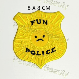May include: Yellow embroidered iron-on patch shaped like a police badge with the words "FUN POLICE" and a yellow frowning face in the center. The patch is 8 by 8 centimeters.