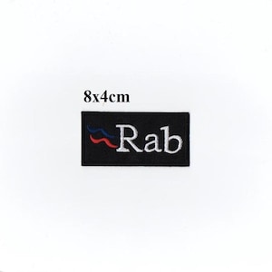 May include: Black embroidered patch with the word "Rab" in white text and a red, white, and blue wave design. The patch measures 8 by 4 centimetres.