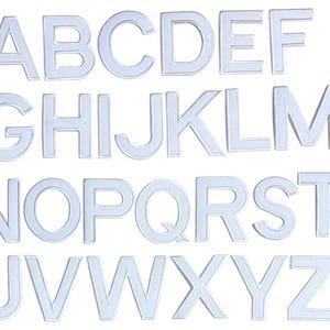 May include: A complete set of capital letters in a light, translucent colour. The letters are arranged in rows and columns against a white background. The letters are in a sans-serif font.
