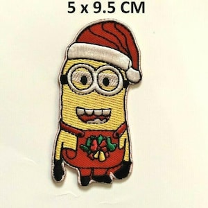 May include: A yellow Minion wearing a red and white Santa hat and a red jumpsuit with a green and red holly and bell design. The patch is 5 x 9.5 cm.