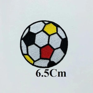 May include: A white, black, red, and yellow embroidered soccer ball patch. The patch is 6.5 inches in diameter.
