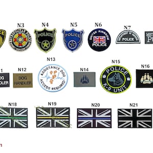 May include: A collection of police and law enforcement patches, including shield and rectangular designs. Patches feature text like "POLICE", "DOG HANDLER", and "K-9 UNIT". Some patches display the Union Jack flag.