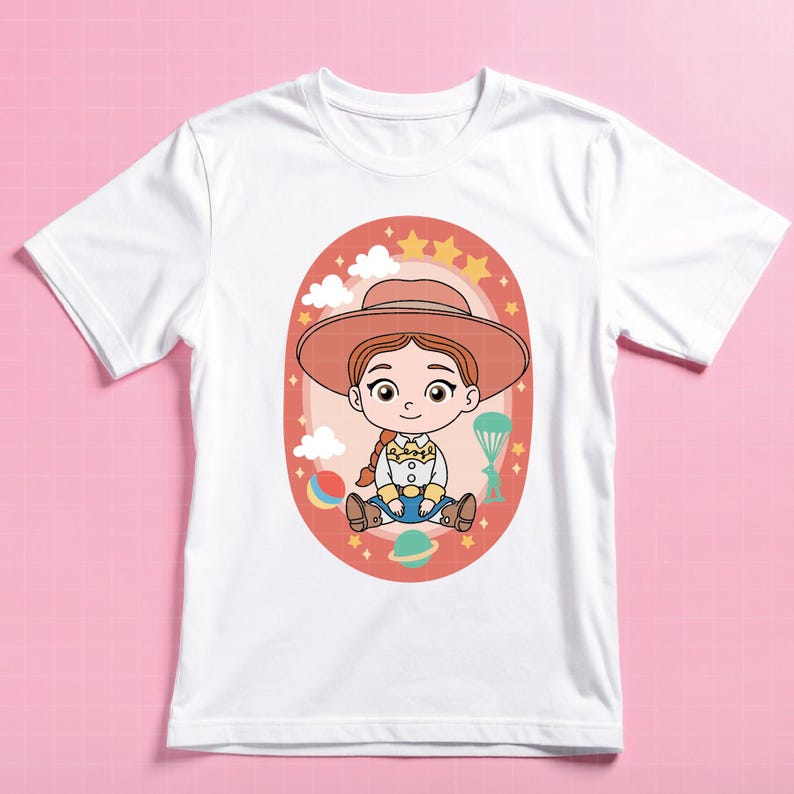 May include: White t-shirt featuring a cartoon illustration of a cowgirl character. The design includes a cowgirl with a hat, surrounded by clouds, stars, and a planet. The character is wearing a hat, a yellow shirt, blue jeans, and brown boots.