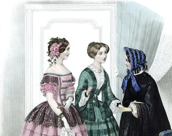 May include: Three women in 19th-century fashion pose for a portrait. The woman on the left wears a pink and black dress with lace trim. The woman in the center wears a green plaid dress with a white lace collar. The woman on the right wears a black dress with a blue bonnet and a red shawl.