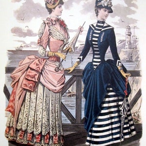 May include: Two women in fashionable 19th-century attire stand on a wooden pier overlooking a harbor. One woman wears a pink and white dress with a lace trim and a large hat with flowers. The other woman wears a navy blue dress with white stripes and a black hat with a white bow.