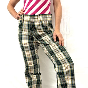 May include: Green, white, and yellow plaid pants. The pants have a wide leg and a high waist. The plaid pattern is a classic design, suitable for casual wear. The pants are made of a soft, comfortable material.