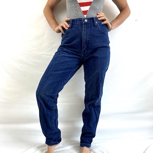K&ouml;nnte beinhalten: Eine blaue Jeans mit hoher Taille und gerader Beinweite.