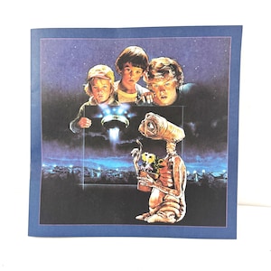 May include: A square print featuring the movie E.T. The Extra-Terrestrial. The image shows three children looking up at a spaceship, with E.T. holding flowers. The background is a night sky with a cityscape.
