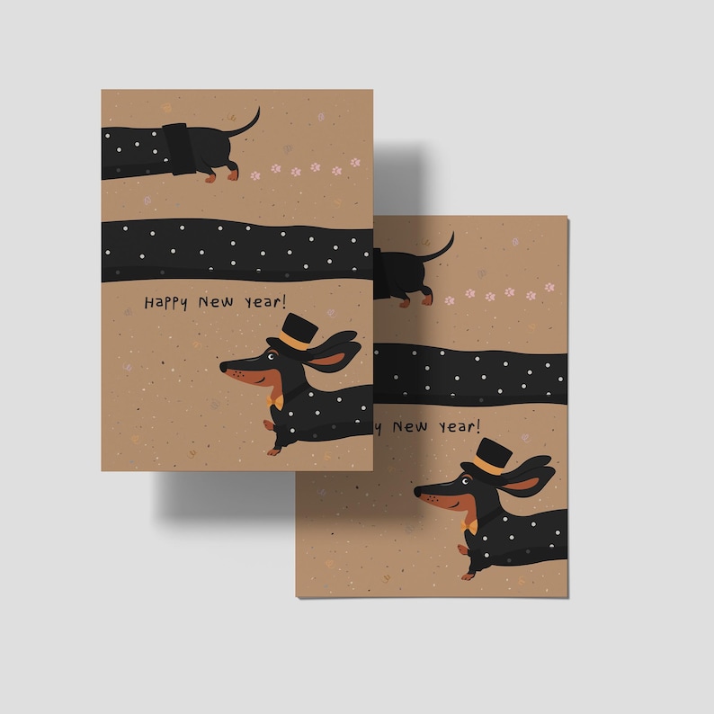 May include: Two greeting cards with a dachshund illustration. The dog is black with white polka dots and a top hat. The cards have the text "Happy New year!" on a tan background with a black dotted line.