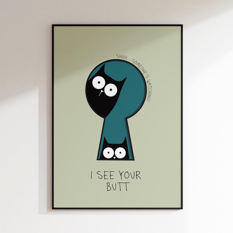 May include: A framed art print featuring a whimsical illustration of a black cat peeking through a teal keyhole. The text reads "SHHH... SOMEONE'S WATCHING!" and "I SEE YOUR BUTT". The background is a light green.