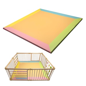 May include: A colorful baby play mat with a pastel color scheme. The mat has a large, rectangular design with a yellow center and borders in pink, green, and blue. A wooden playpen surrounds the mat.