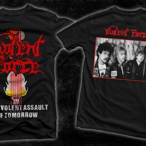 May include: Black t-shirt with a red and white graphic of a guitar and the text "Violent Force" and "Malevolent Assault of Tomorrow". The back of the shirt has a black and white photo of a band with the text "Violent Force" in red.