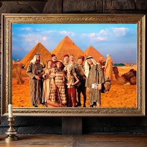 May include: A group of people dressed in various clothing stand in front of the pyramids in Egypt. The group includes a man wearing a striped robe, a woman wearing a long floral dress, and a child wearing a red and white dress. The group is smiling and looking at the camera.