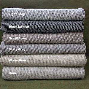 May include: A stack of six fabric swatches in various shades of gray, including light gray, black and white, gray and brown, misty gray, warm hoar, and hoar.