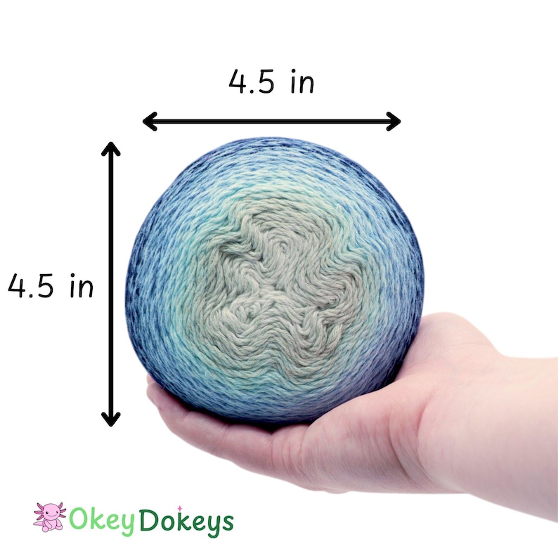 May include: A ball of yarn, approximately 4.5 inches in diameter, held in a hand. The yarn is a gradient of blues, greens, and cream colors. The text "4.5 in" is displayed on the image. The Okey Dokeys logo is in the bottom left corner.