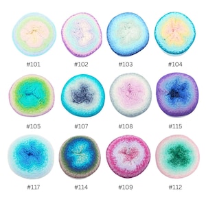 May include: Twelve round skeins of gradient yarn arranged in a grid, each labeled with a number from #101 to #117. The yarn balls feature various color combinations including pastel, blue, green, purple, and pink transitions in a soft texture.