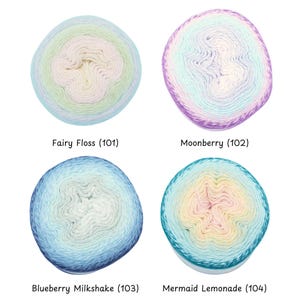 May include: Four skeins of colorful yarn are displayed, each with a unique gradient. The colors include pastels like blue, green, and pink, with names like "Fairy Floss" and "Mermaid Lemonade" printed below each skein.