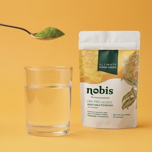 May include: A white pouch of Nobis Ultimate Super Green Ora Pro Nobis vegetable powder next to a clear glass of water. A metal spoon pours green powder into the water. The pouch text includes Net Wt. 5.3 oz (150g) and 30 servings.