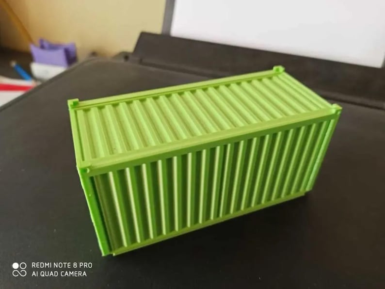 May include: A small, green, plastic shipping container with a corrugated texture.