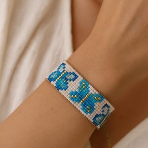 Woven bracelet with butterfly pattern beads - pink, purple and gold colors, blue colors