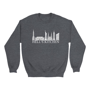 May include: Dark heather grey sweatshirt with a white graphic of the New York City skyline and the text "Hell's Kitchen".
