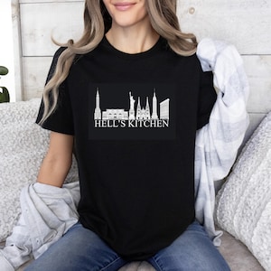 May include: Black t-shirt with a white graphic of the New York City skyline and the text "Hell's Kitchen".