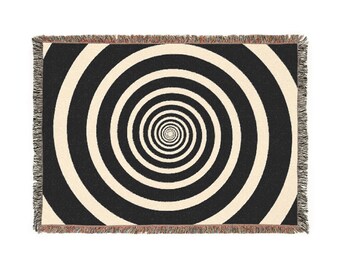 May include: Black and white woven throw blanket with a swirling spiral pattern.