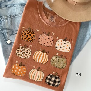Boho fall pumpkin shirt featuring nine hand drawn pumpkins with leopard print, florals, hearts, polka dots, stripes and plaid patterns, perfect for a cute autumn outfit, pumpkin season, Thanksgiving and cottagecore fall style.