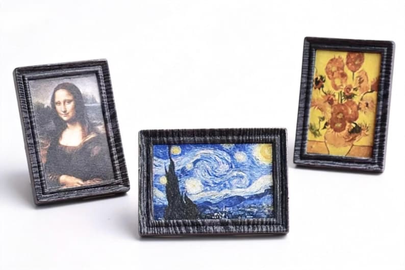 May include: Miniature framed art prints featuring famous paintings. Includes a print of the Mona Lisa, Van Gogh's Starry Night, and a floral still life. Each print is in a dark gray textured frame.