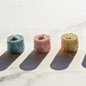 May include: A set of three ceramic mugs with a speckled, matte finish. The mugs are in shades of cream, light gray, and dark gray. Each mug has a simple, minimalist design, perfect for coffee or tea.