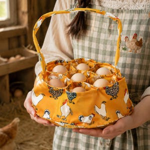 May include: A yellow fabric egg basket featuring a repeating pattern of white and brown chickens. The basket has a matching fabric handle and individual circular compartments, each holding a single light brown egg, arranged in a circular formation.