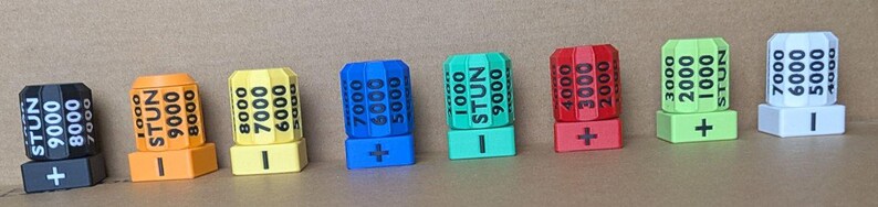 May include: A white ceramic mug with a black handle and the text "But First, Coffee" in a handwritten style. The mug is on a white surface. The mug is 10 cm tall.