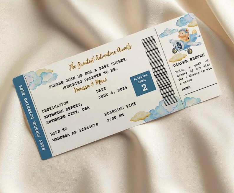 May include: A blue and white baby shower invitation in the shape of an airplane ticket. The invitation features a watercolor design with clouds and a cartoon airplane with a teddy bear pilot. The text reads "The Greatest Adventure Awaits" and includes details about the event, such as the date, time, and location. It also mentions a diaper raffle.