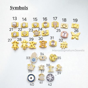 May include: A selection of gold-coloured charms featuring diverse symbols like a pearl, heart, star, paw print, crown, and butterfly. The charms are numbered and presented on a white background. The word "Symbols" is at the top.
