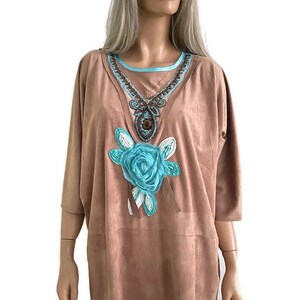 May include: A light brown suede top with a turquoise and brown beaded neckline and a large turquoise flower applique.